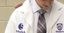 Image of a young man recieving his white coat