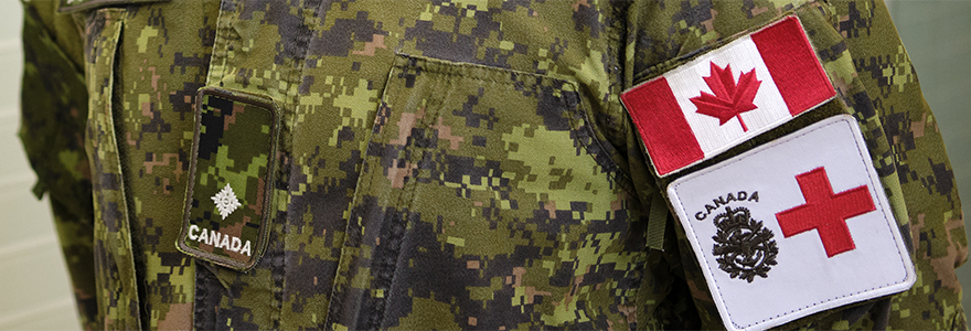 Photo of the uniform sleeve with Canadian flag and the red cross.