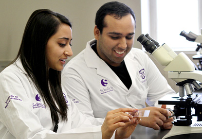 Neuroscience students at microscope