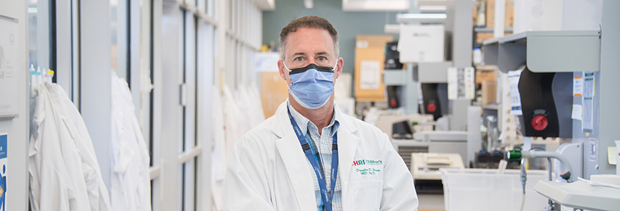 Dr. Doug Fraser wearing a mask in his lab