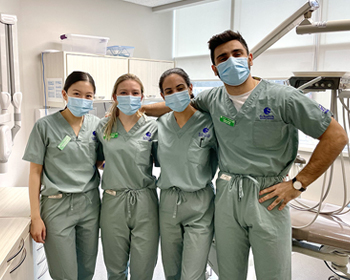 Daniel Bitar and classmates in a dental clinic operatory