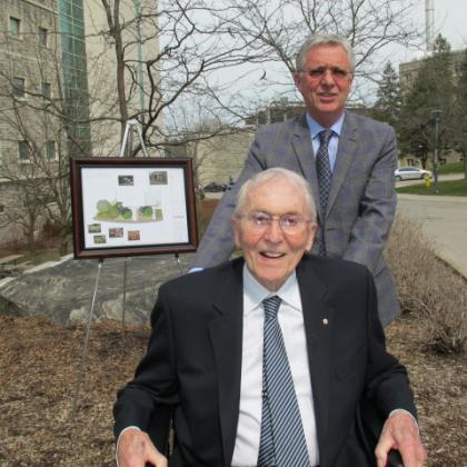 Dr. Henry Barnett and his son William in front of the design for the new garden