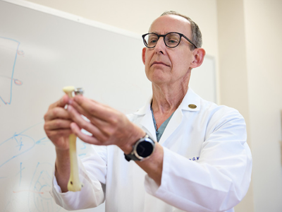 Dr. Graham King examines an implant