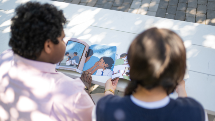 Students looking at their book