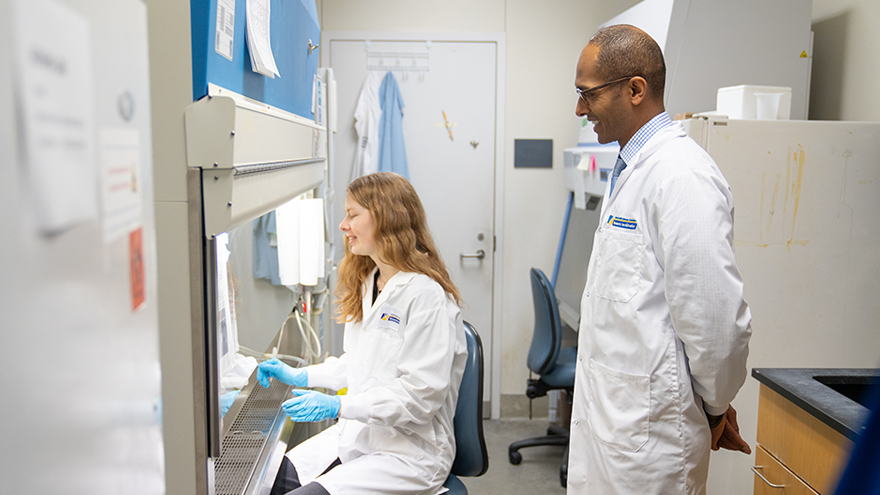 Frederikke Larsen and Dr. Samuel Asfaha in the lab