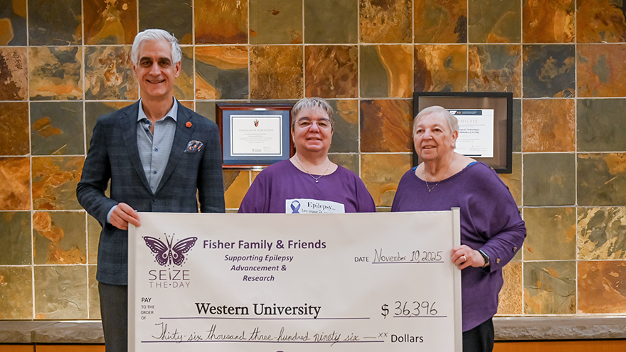 Karen Fisher and her mother presenting a cheque to Dr. David Steven