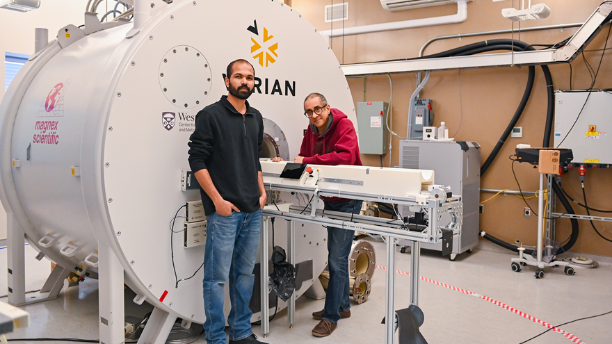 Renil Mathew, PhD Candidate, and Ravi Menon, PhD, with the 15.2T MRI scanner