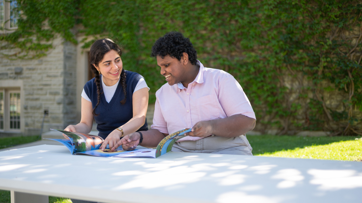 Students Nadith Ranasinghe and Bahareh Rahimi Shahmirzadi with their books.
