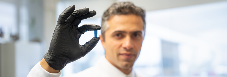 Saman Maleki, PhD, holds a so-called ‘poop pill’ used for fecal microbiota transplants. New findings show promising results in kidney, skin and lung cancer treatment. (London Health Sciences Centre)