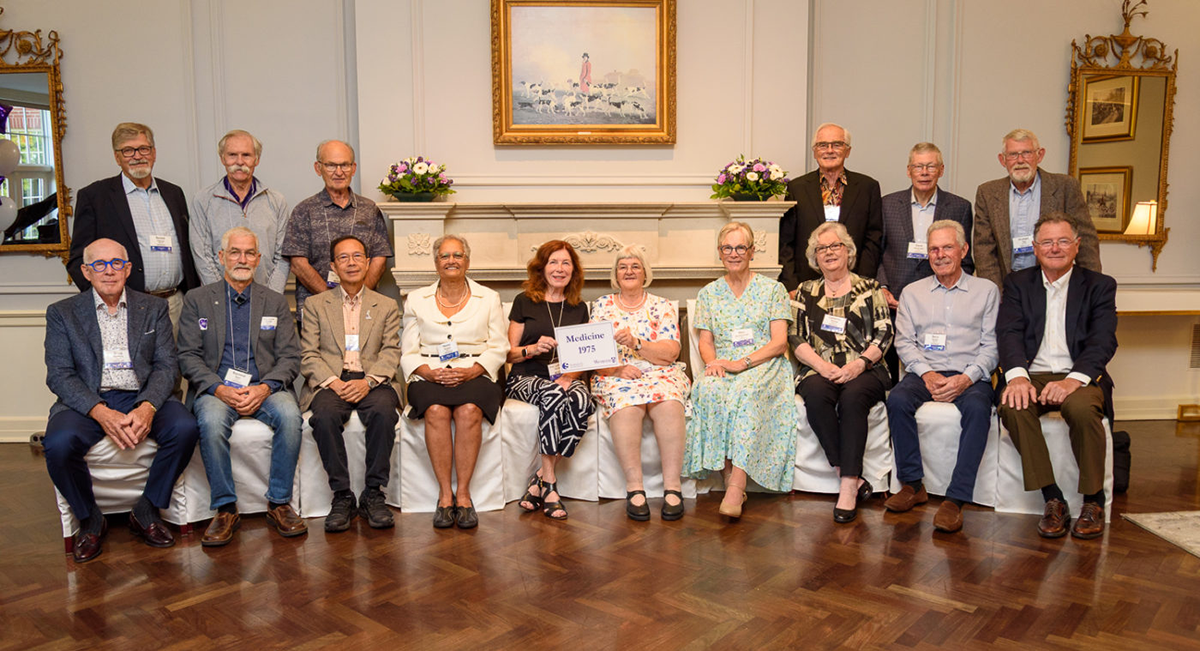 Group of medical alumni posing together at a reunion event.