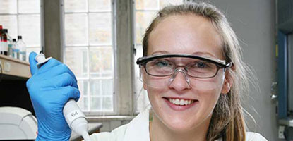 photo of student holding a pipettor in lab