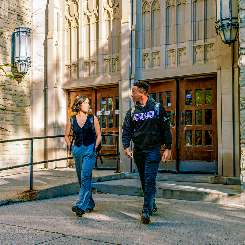 Two students walking outside the Medical Sciences building