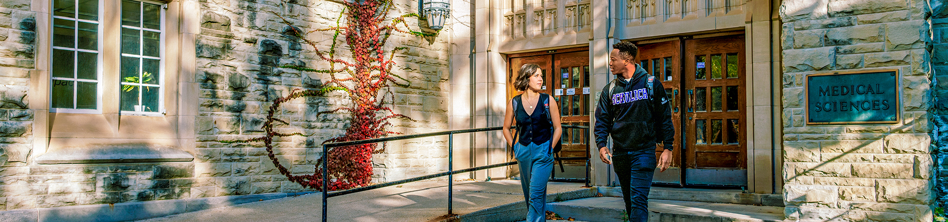 Two students walking outside the Medical Sciences building