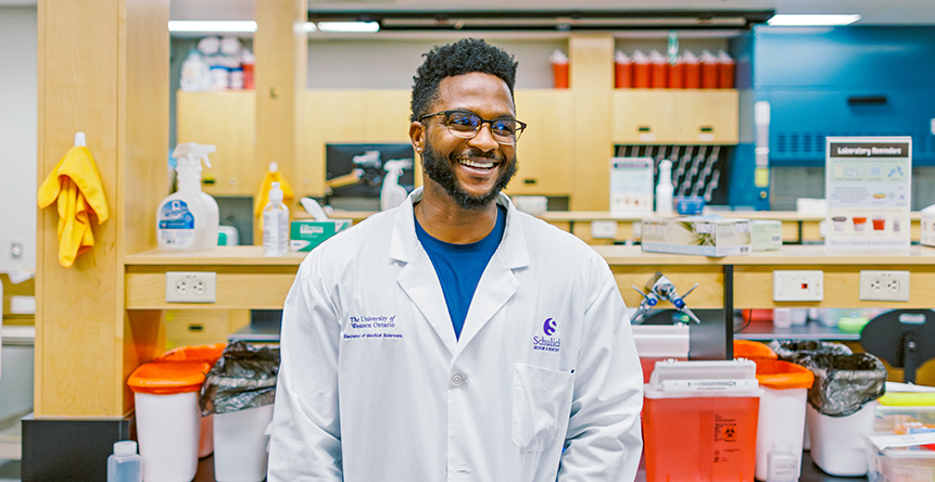 Students in lab coats working with pipettes