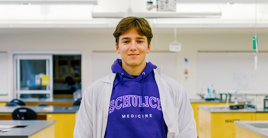 Three students in Schulich Medicine sweaters talking indoors.