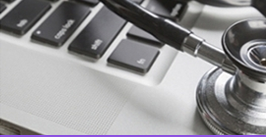 Stethoscope resting on a laptop keyboard.