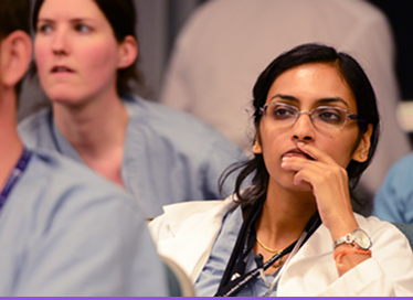 Woman in an audience listening attentively