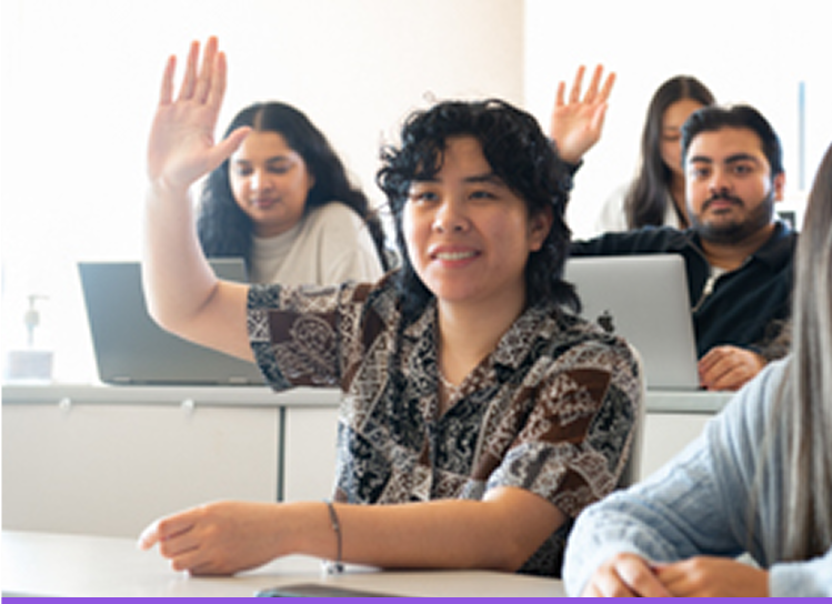 Students in a classroom raising their hands