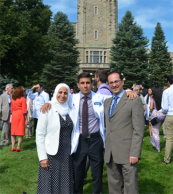 Photograph of Amr Alsabbagh with his parents at White Coat ceremony