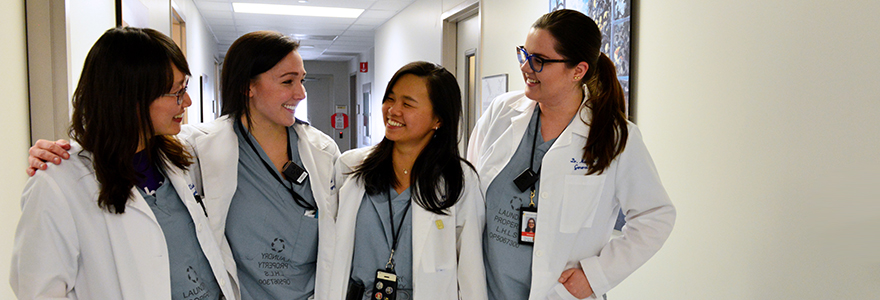 Photograph of residents standing in a hospital hallway