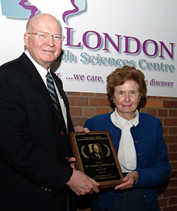 Mrs. Drake presents Dr. Rhoton with his plaque