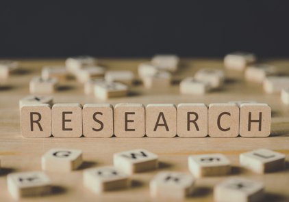 The word "research" spelled with wooden blocks