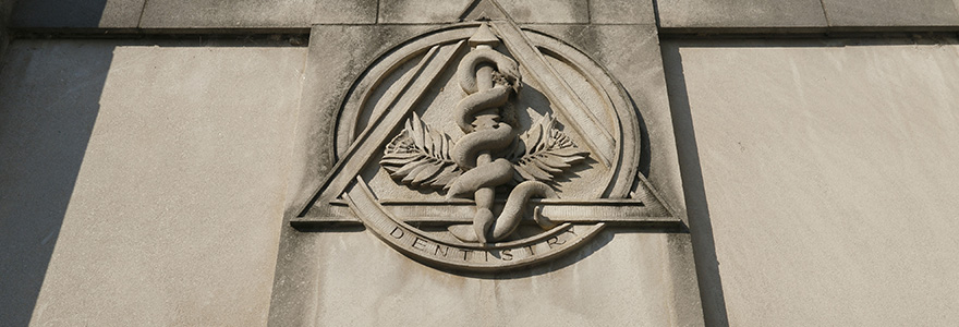 Photograph of the Dentistry crest on building