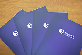 Purple document folders branded with the School and University brand