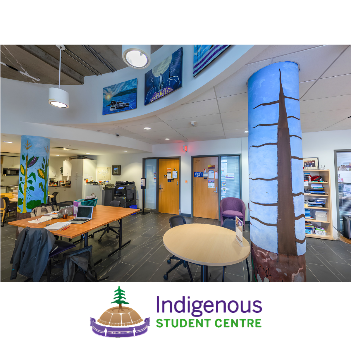 inside an office with two painted pillars and tables