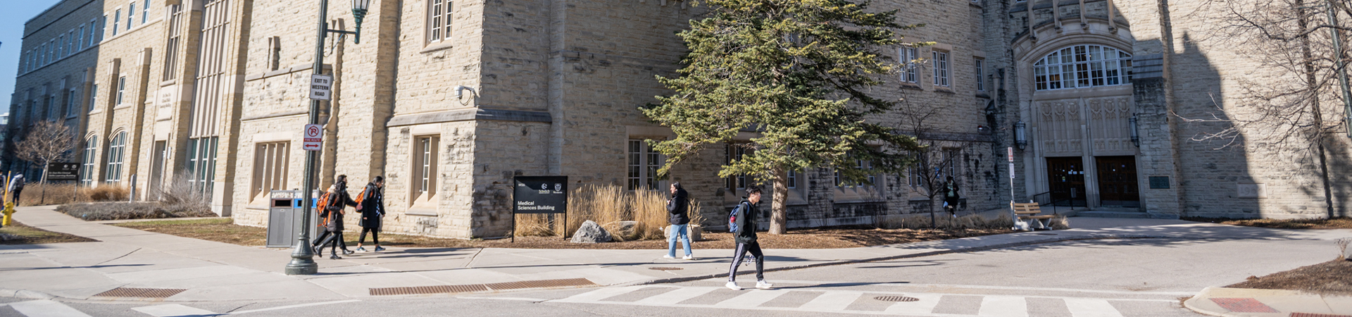 Wide view of the Medical Sciences Building exterior under a blue sky