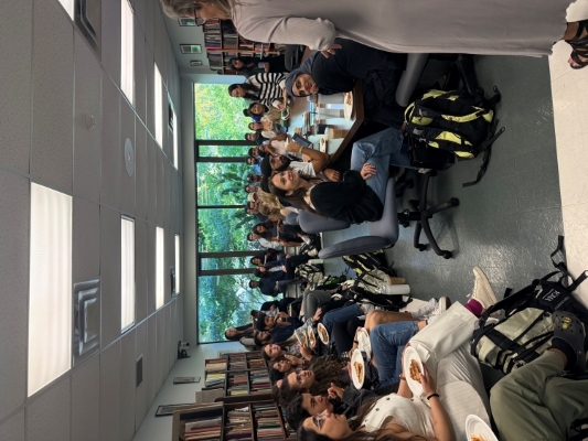 Dr. Shelley McKellar stands in front of a seated crowd, addressing them