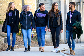 Five students walking outside