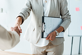 Photograph of recruiter and employee shaking hands