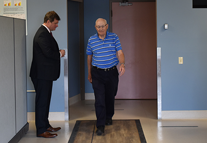 Dr. Montero-Odasso looks on as an elderly patient walks across the floor