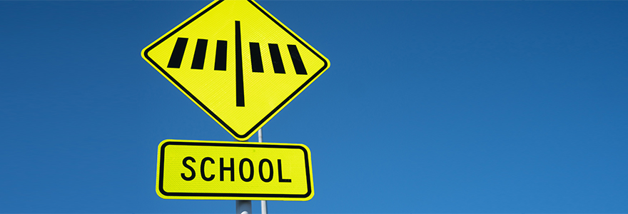 School crossing sign with blue background