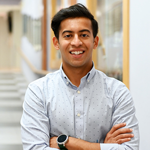 Jayneel Limbachia standing in the hallway of a building on campus