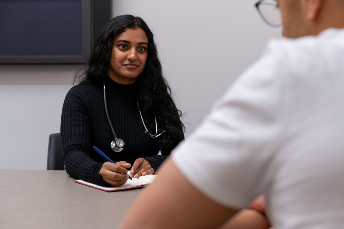 A medical student consults with a peer, focusing on advanced family medicine knowledge.