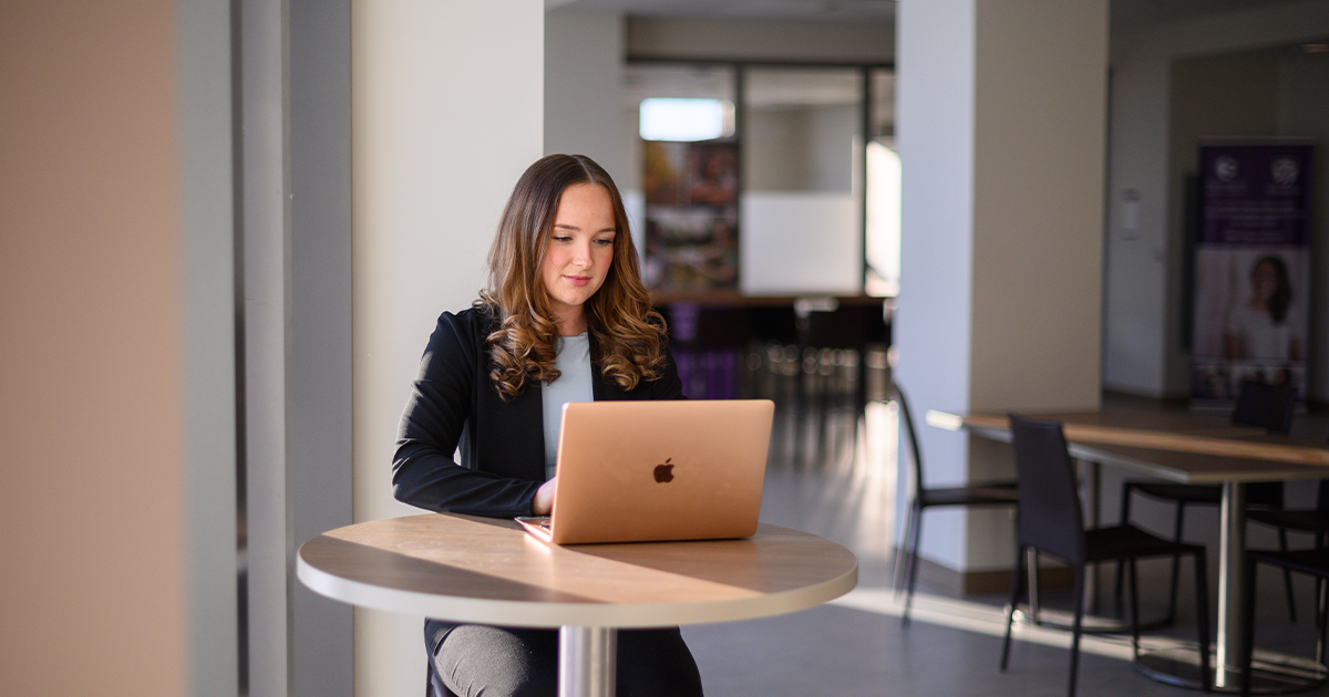 Students seated in a classroom discussion, reviewing course material together.