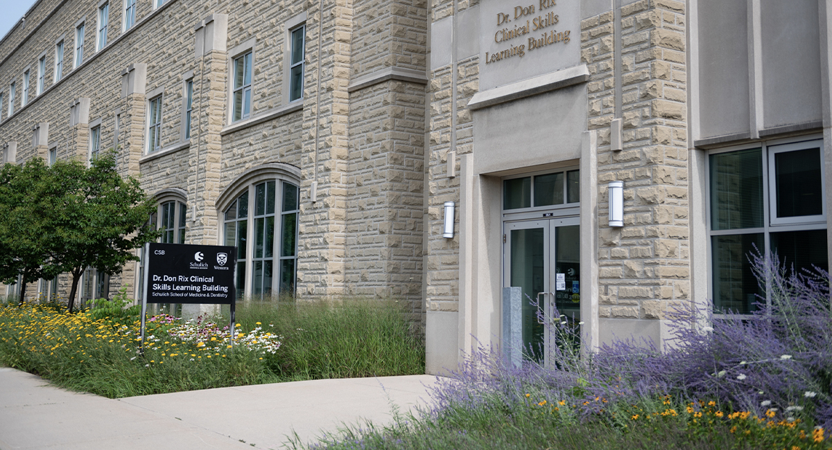 Clinical Skills Building entrance with flowers along the walkway