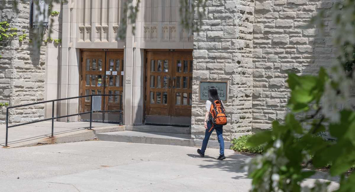 Student walking past the Medical Sciences Building entrance