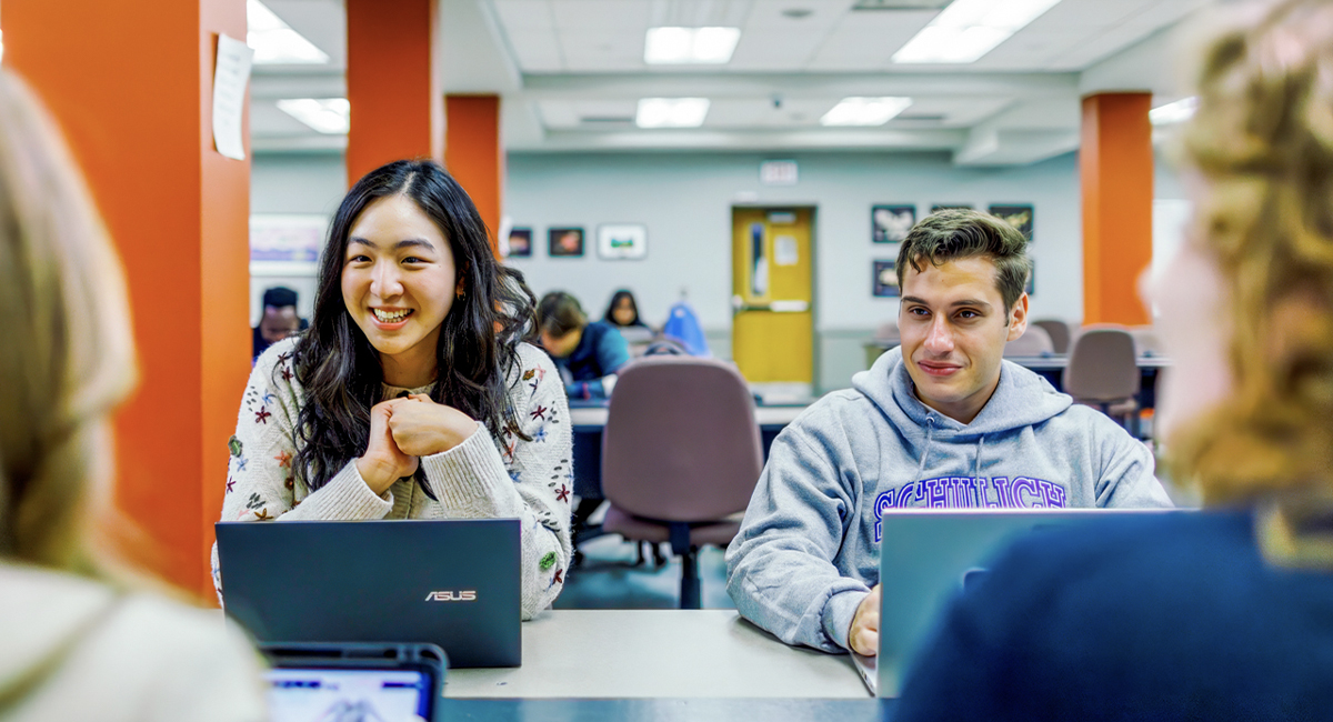 Students working on laptops in a classroom