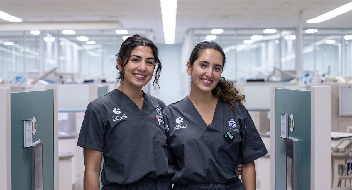 Two dentistry students standing in a dental clinic