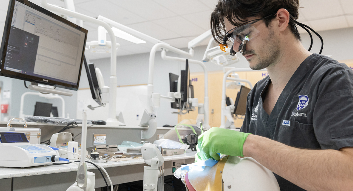 Dental student practicing a procedure in a simulation lab