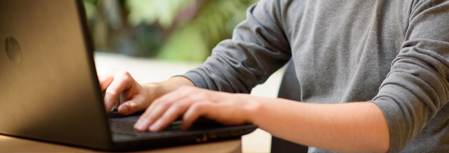hands typing on a laptop