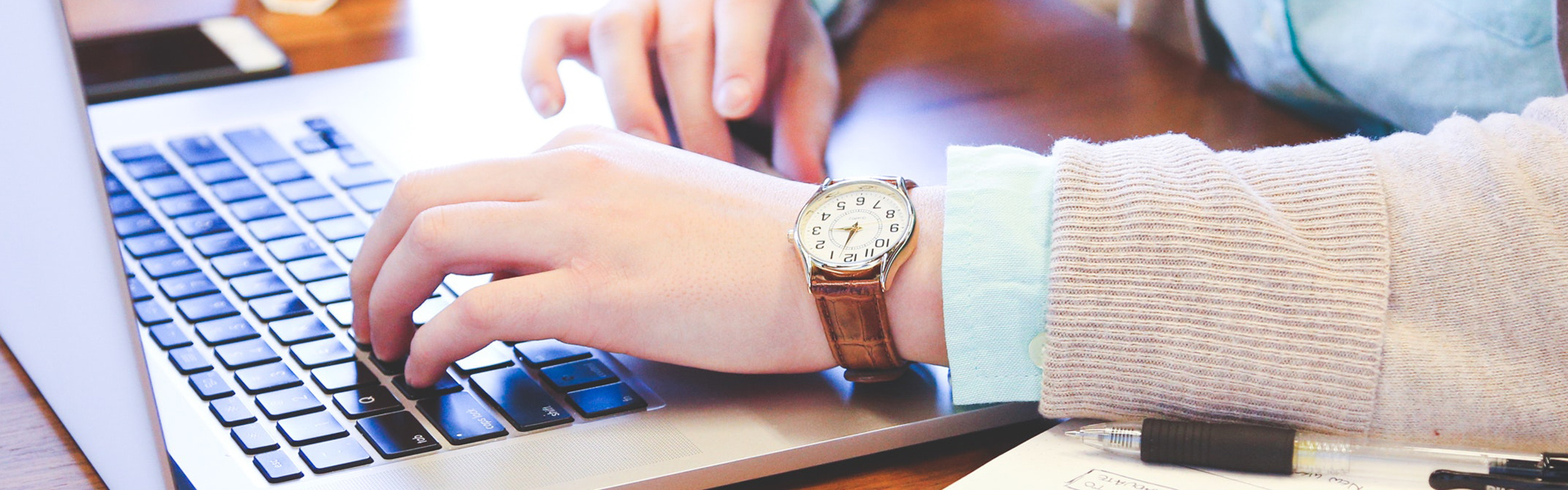 female hands typing on a laptop