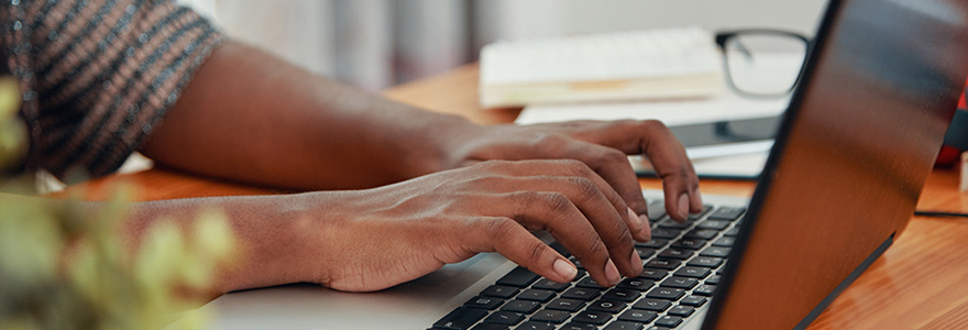 hands typing on a laptop