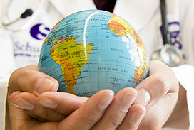 Photograph of hands holding a globe