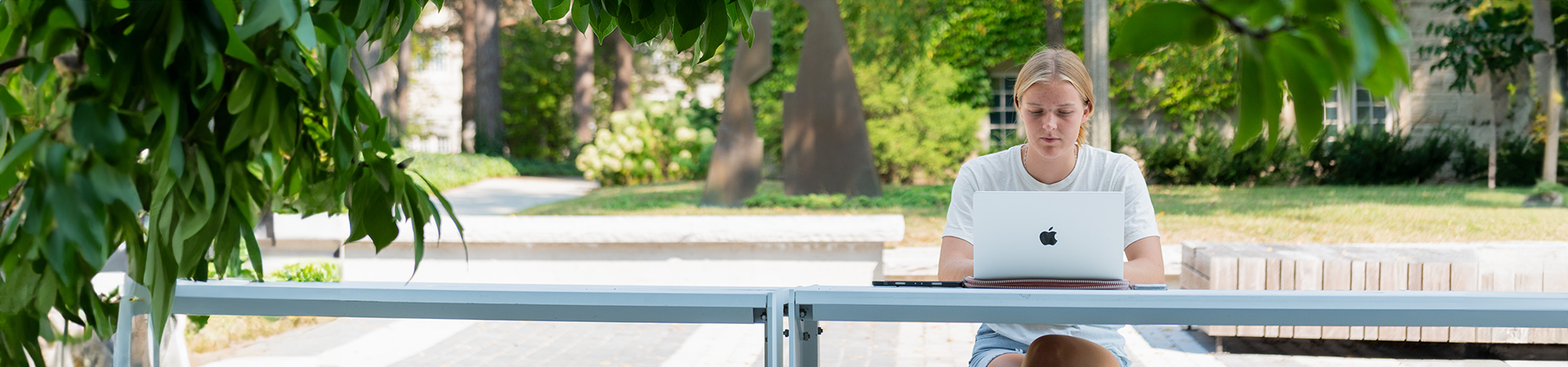 A visiting student is studying on campus