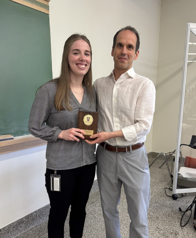 Cassandra Edgar, award recipient, and Jimmy Dikeakos, supervisor, smiling and holding award plaque.