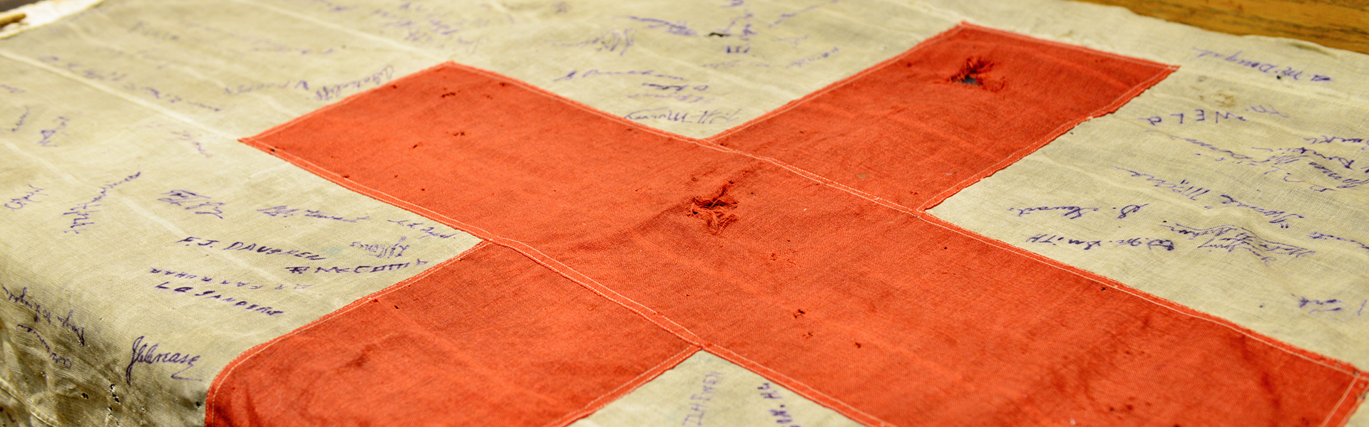 The red cross flag flown at the No. 10 Canadian Stationary Hospital was signed by members of the hospital when the war ended.
